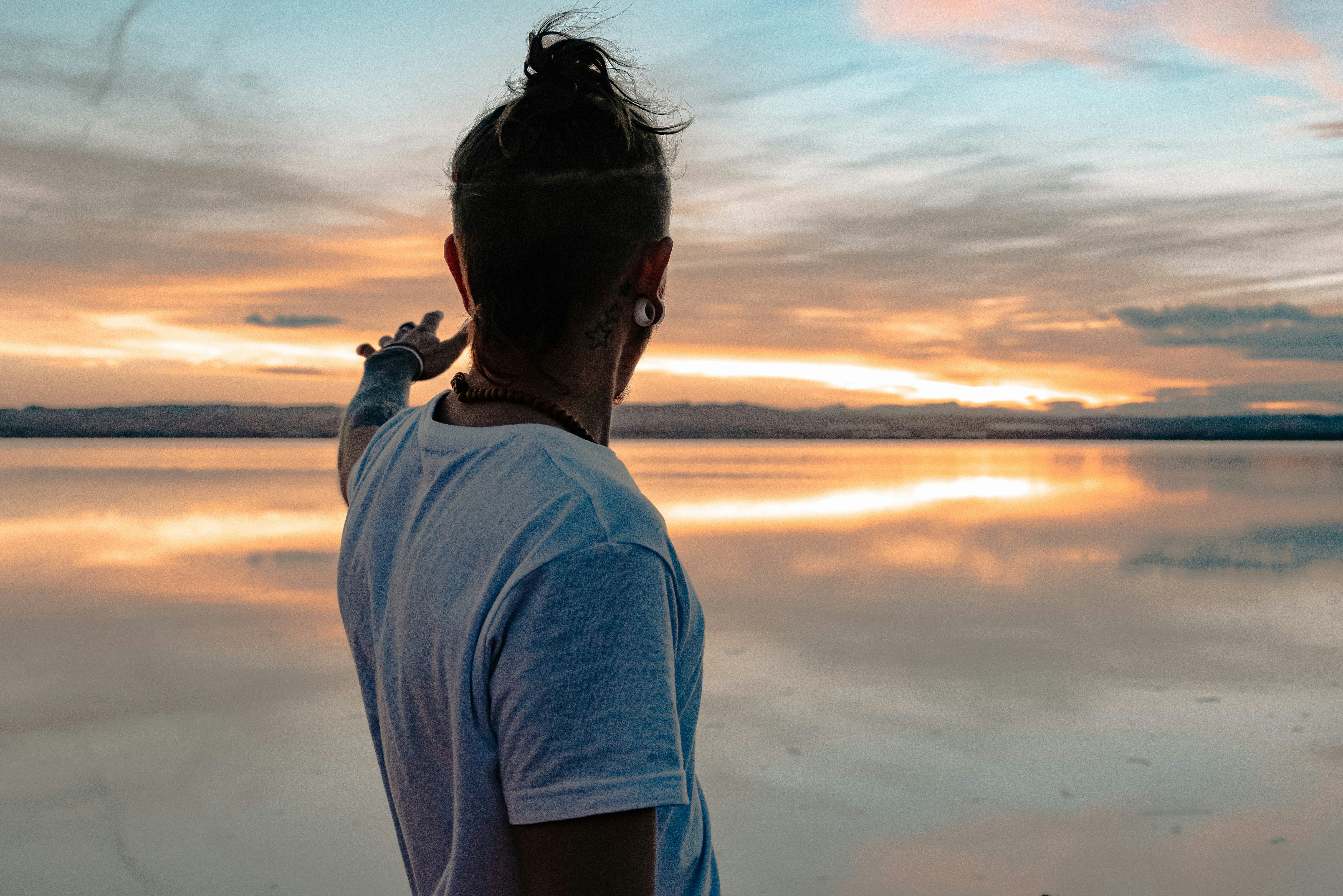 A person writing in a notebook during a quiet reflective moment.